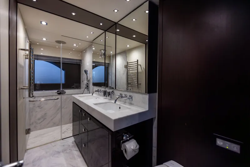 Journey Yacht Photos Pics Luxurious bathroom in 2019 Sunseeker 76 yacht with marble finishes and modern fixtures.