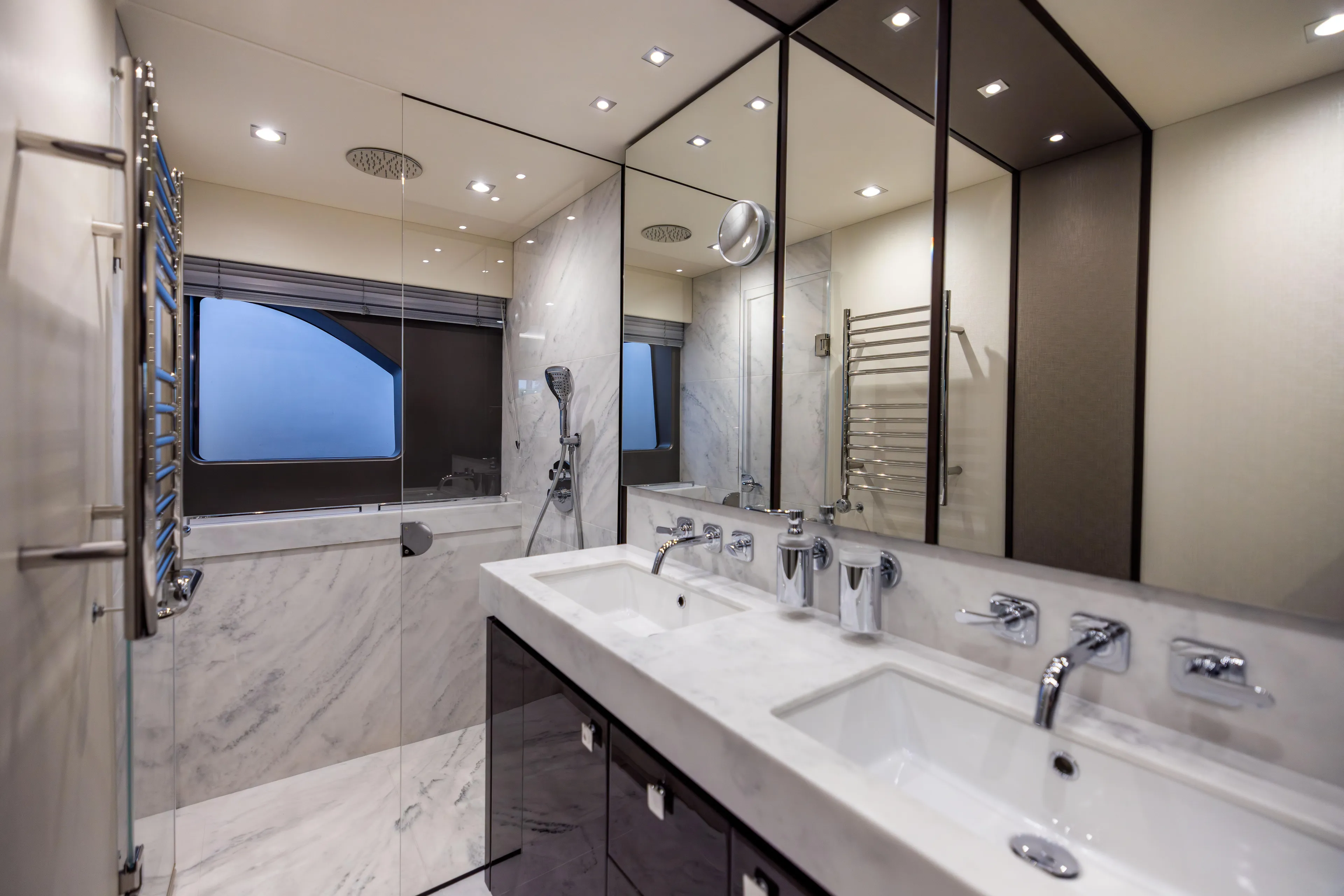 Journey Yacht Photos Pics Luxurious bathroom in 2019 Sunseeker 76 yacht with marble finishes and modern fixtures.