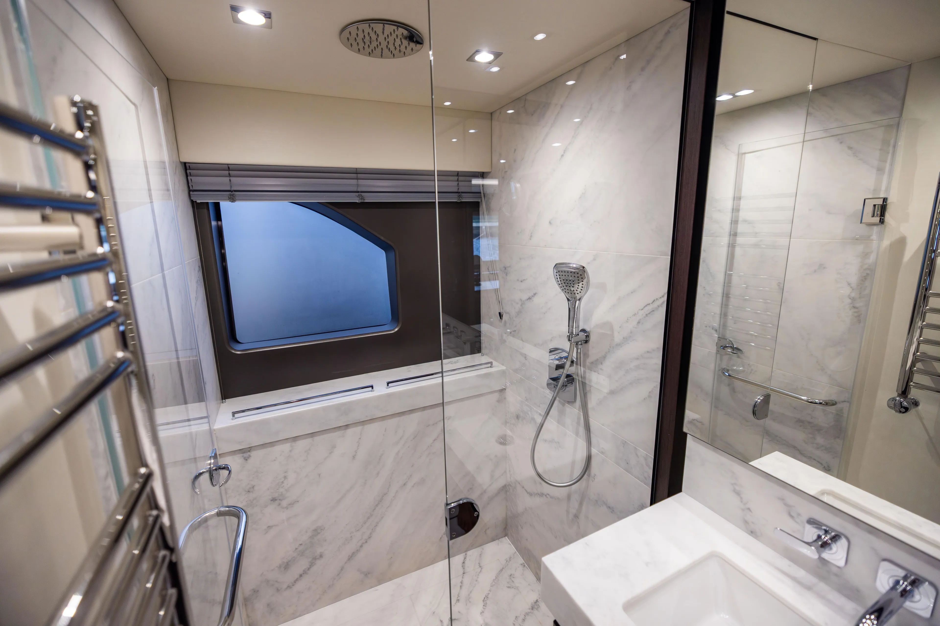 Journey Yacht Photos Pics Luxurious bathroom in 2019 Sunseeker 76 yacht with marble finishes and modern fixtures.