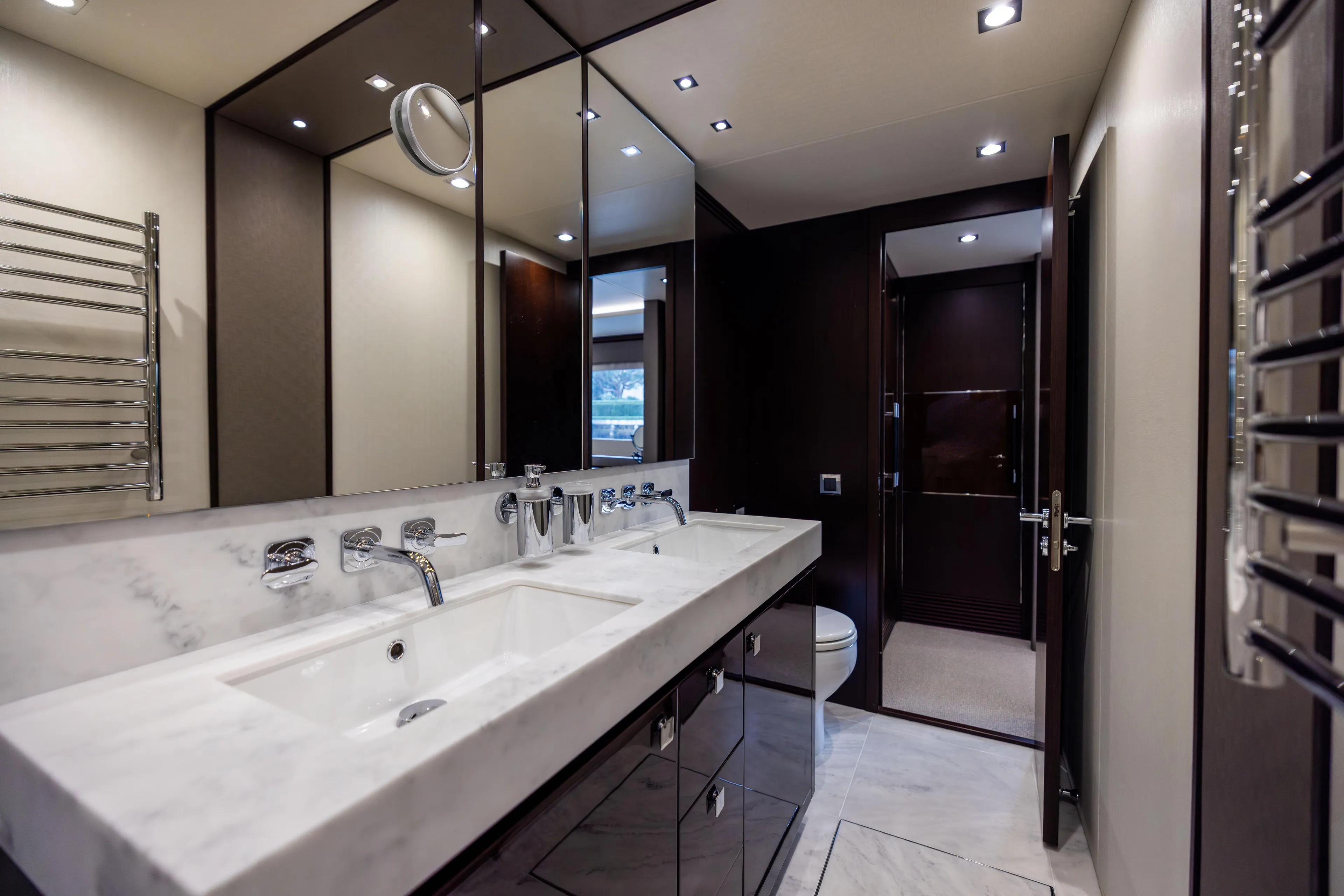 Journey Yacht Photos Pics Luxurious bathroom interior on a 2019 Sunseeker 76 yacht, featuring dual sinks and modern fixtures.
