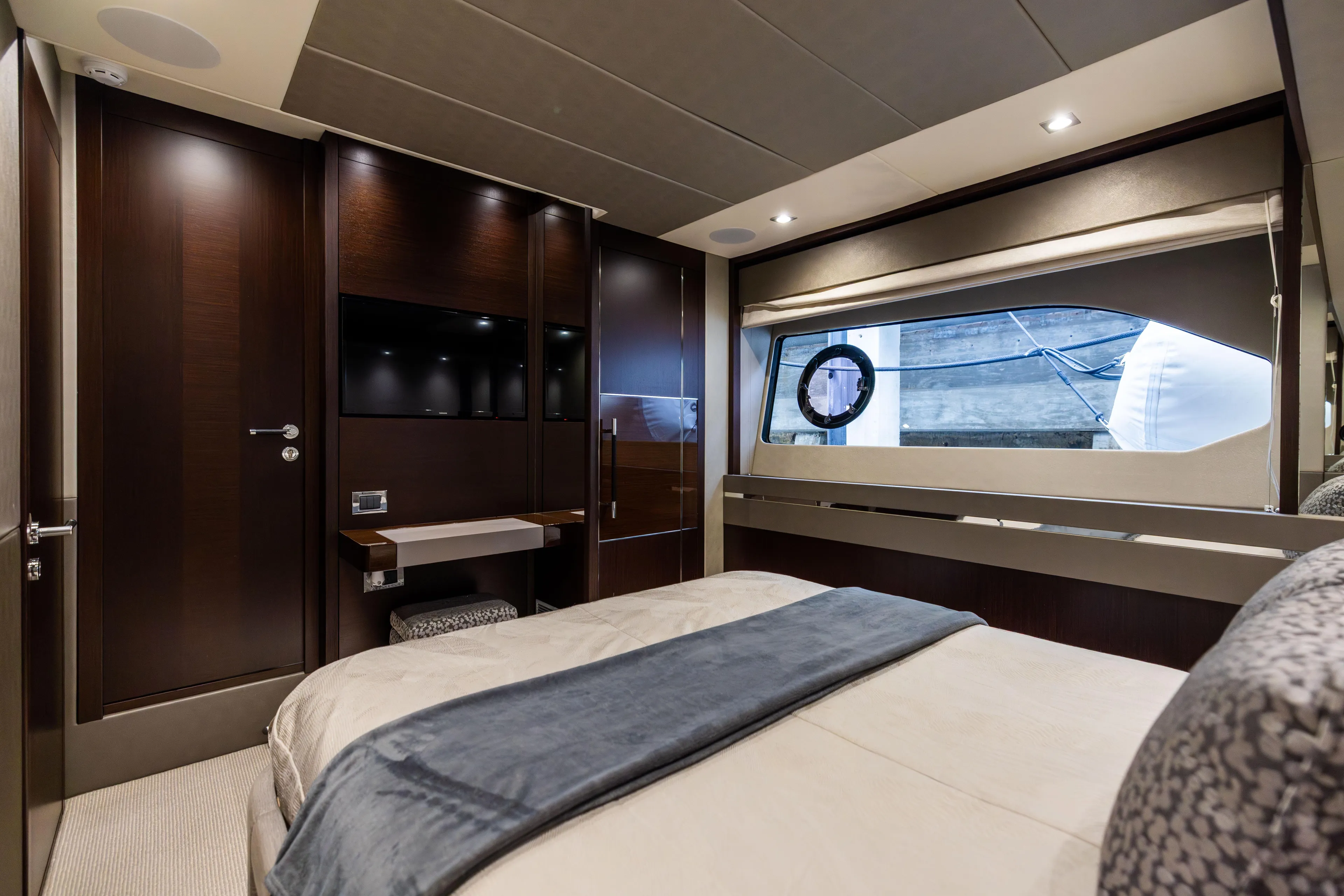 Journey Yacht Photos Pics Luxurious interior of 2019 Sunseeker 76 yacht bedroom with modern design and window view.