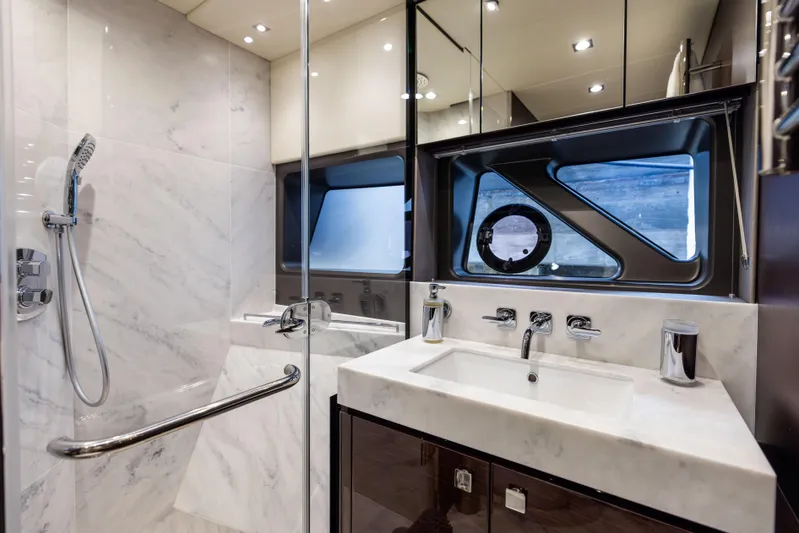 Journey Yacht Photos Pics Luxurious bathroom in 2019 Sunseeker 76 yacht with marble finishes and modern fixtures.