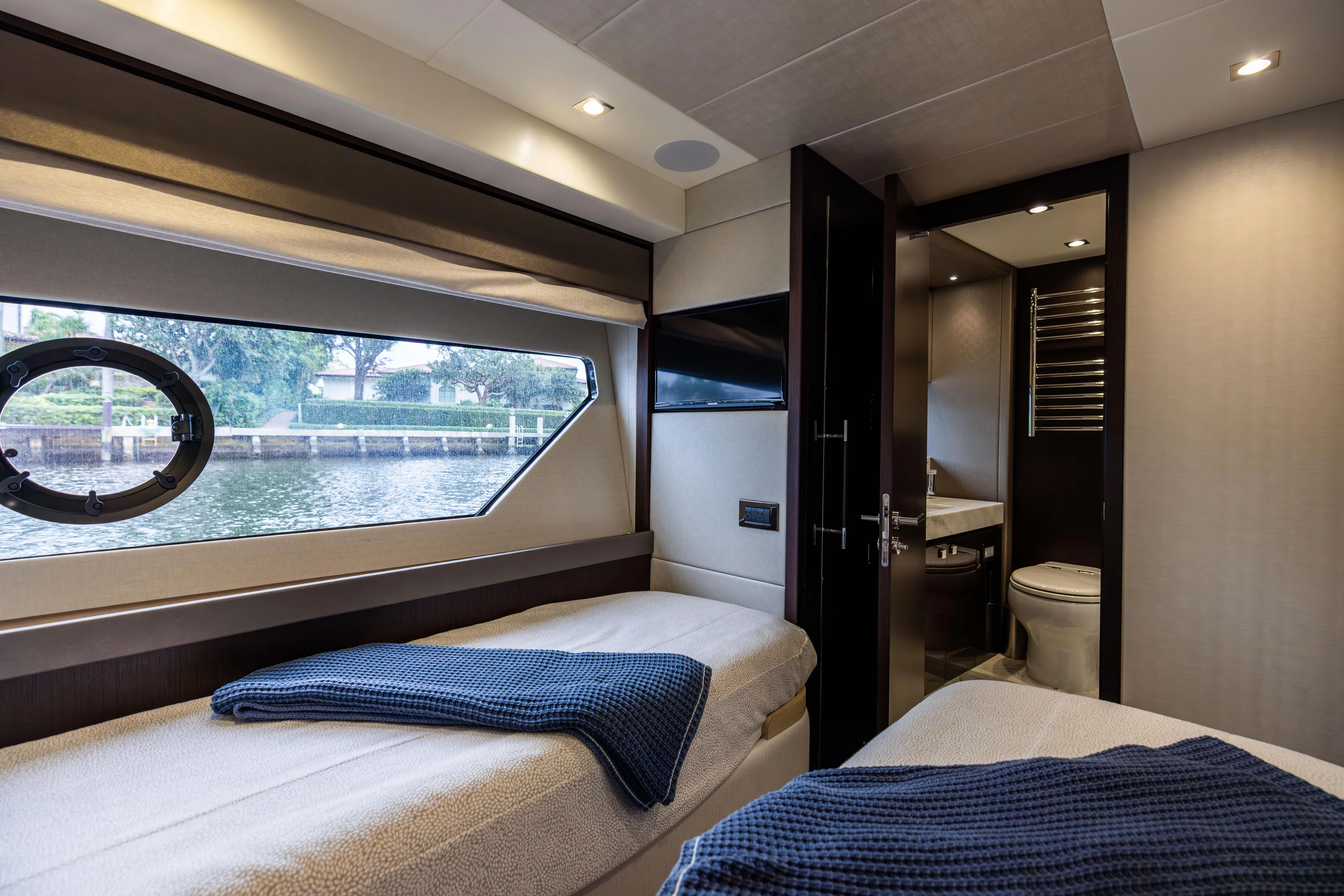 Journey Yacht Photos Pics Luxurious interior of 2019 Sunseeker 76 yacht with twin beds and en-suite bathroom.