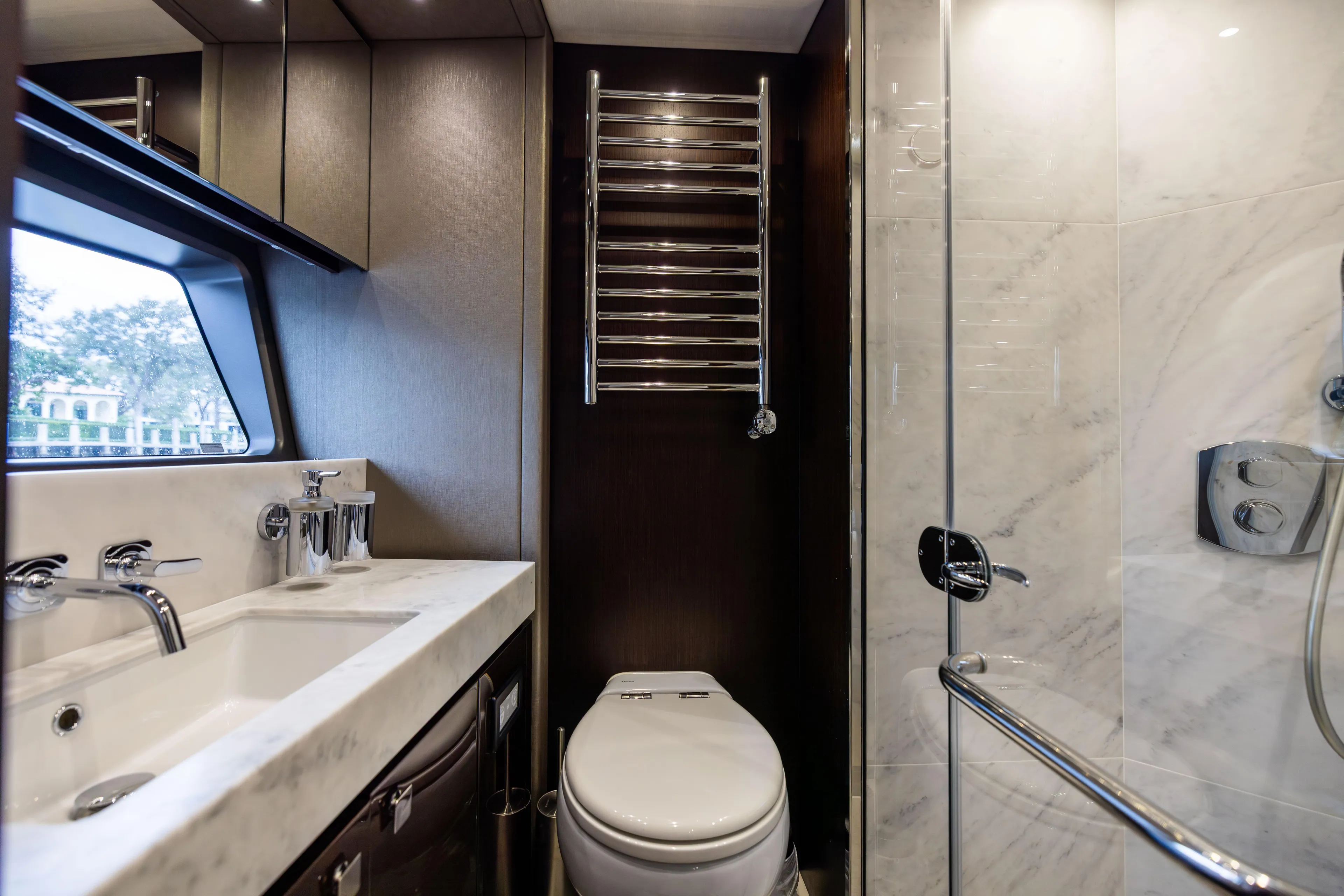 Journey Yacht Photos Pics Luxurious bathroom in 2019 Sunseeker 76 yacht with modern fixtures and marble accents.
