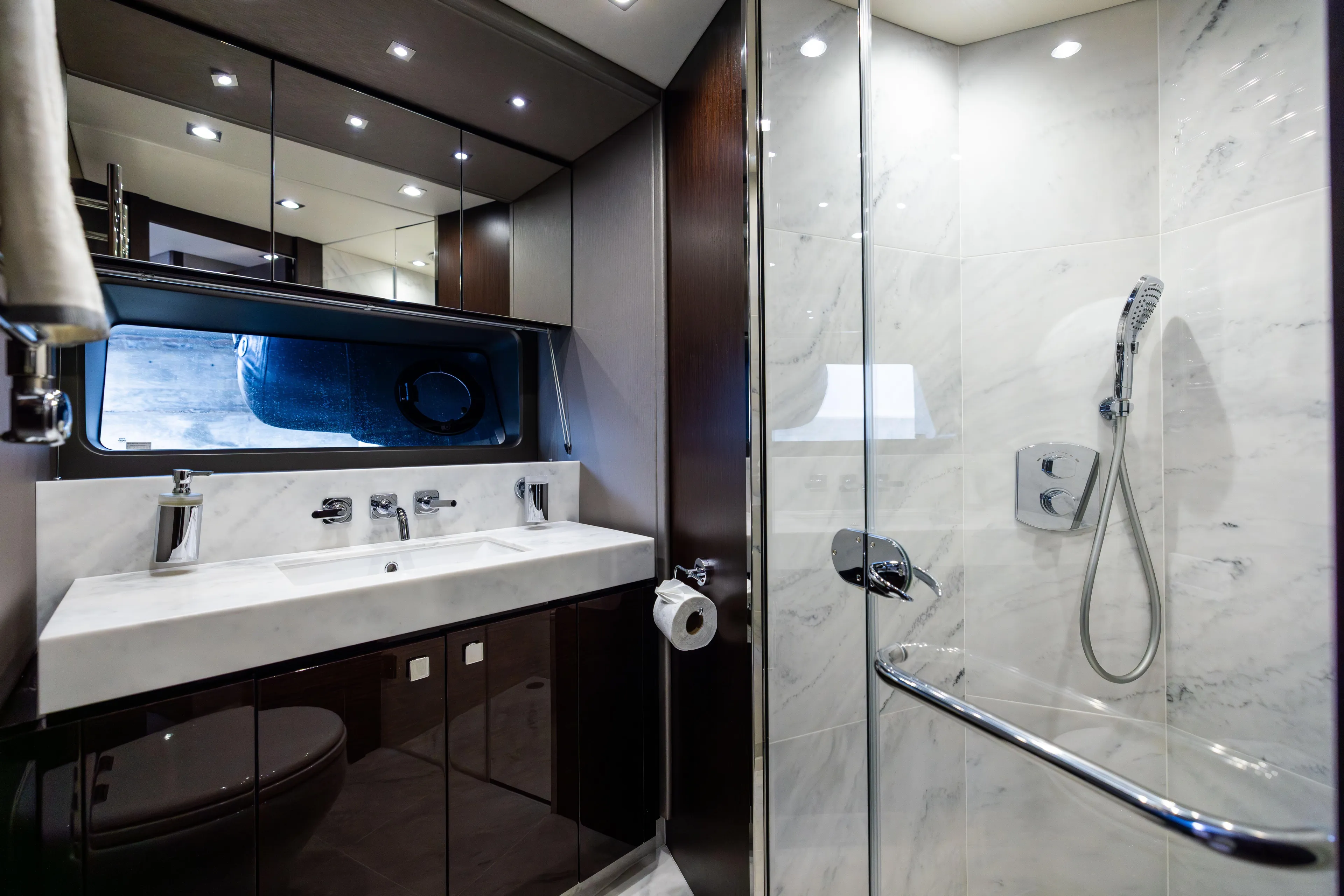 Journey Yacht Photos Pics Luxurious bathroom in 2019 Sunseeker 76 yacht with marble and modern fixtures.