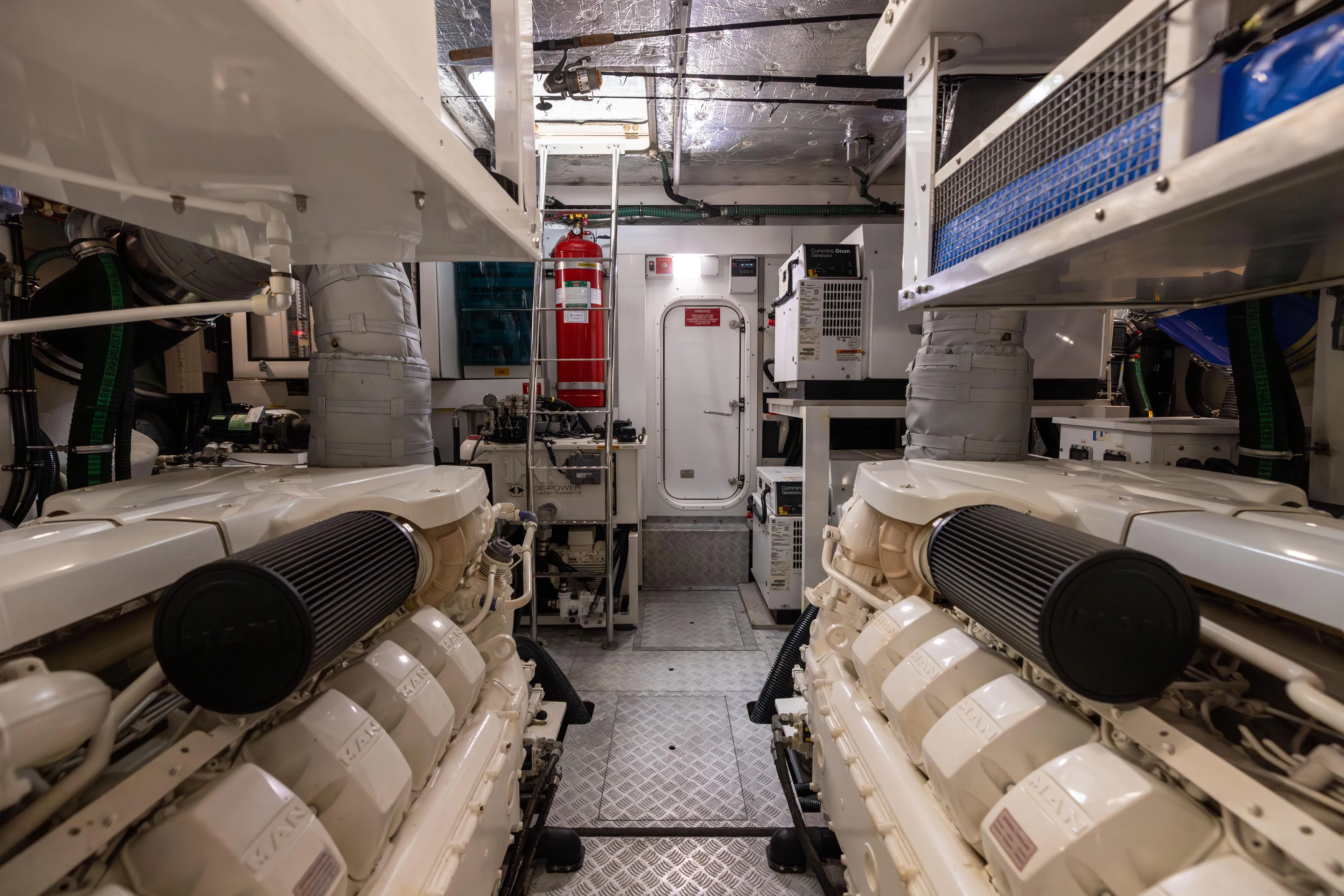 Journey Yacht Photos Pics Engine room of a 2019 Sunseeker 76 yacht, featuring dual engines and equipment.