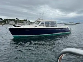Corsair Yacht Photos Pics 2020 MJM 35z boat on calm water under cloudy sky.