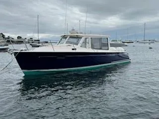 Corsair Yacht Photos Pics 2020 MJM 35z boat on water, cloudy sky, other boats in background.