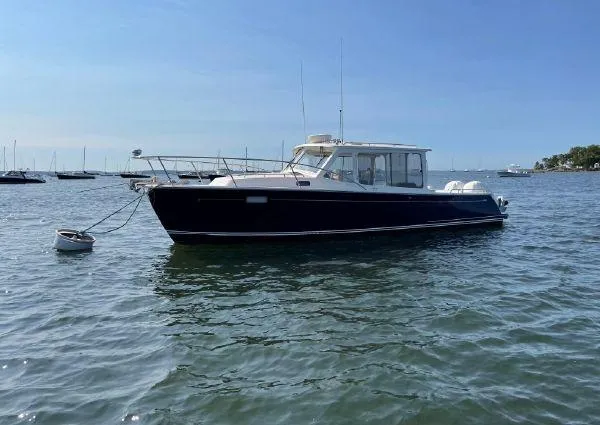 Corsair Yacht Photos Pics 2020 MJM 35z boat anchored on calm water under clear blue sky.