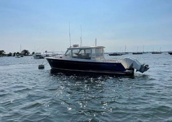 Corsair Yacht Photos Pics 2020 MJM 35z boat on calm water with other boats in the background.
