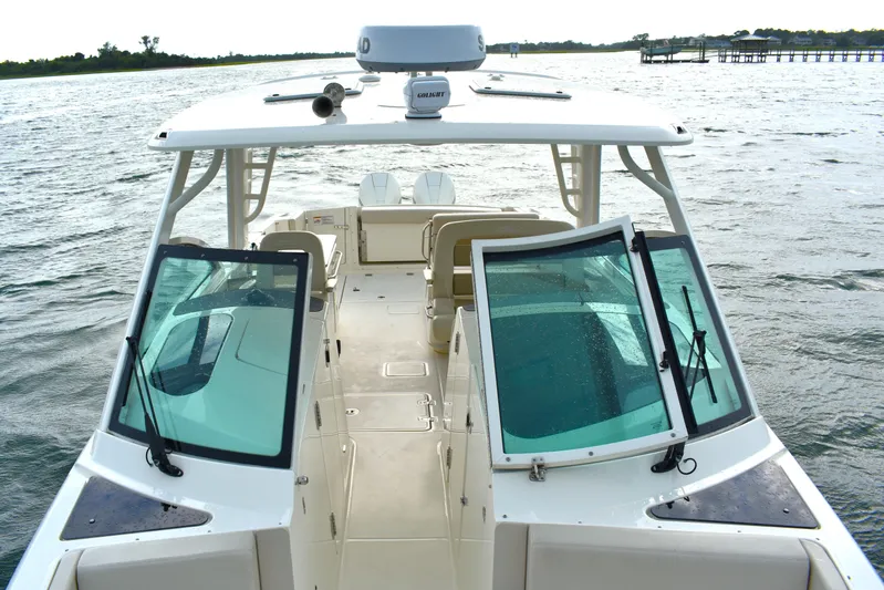  Yacht Photos Pics 2023 Boston Whaler 320 Vantage boat on water, showcasing spacious deck and windshield.