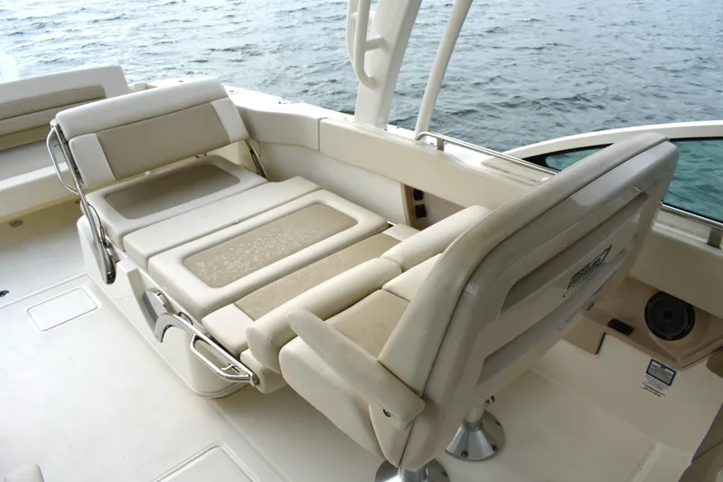  Yacht Photos Pics 2023 Boston Whaler 320 Vantage boat interior with adjustable seating near water.