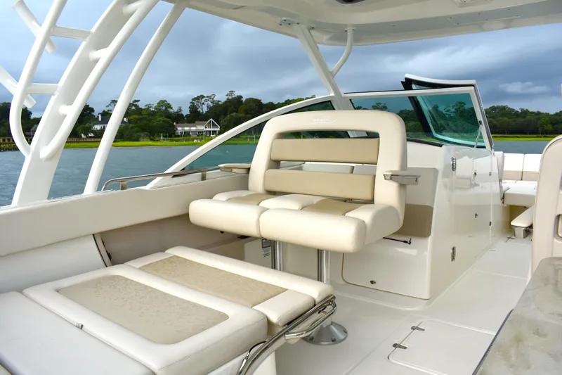  Yacht Photos Pics 2023 Boston Whaler 320 Vantage boat interior with luxurious seating and scenic water view.