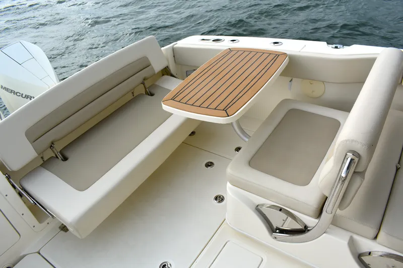 Yacht Photos Pics 2023 Boston Whaler 320 Vantage boat interior with seating and table, on water.