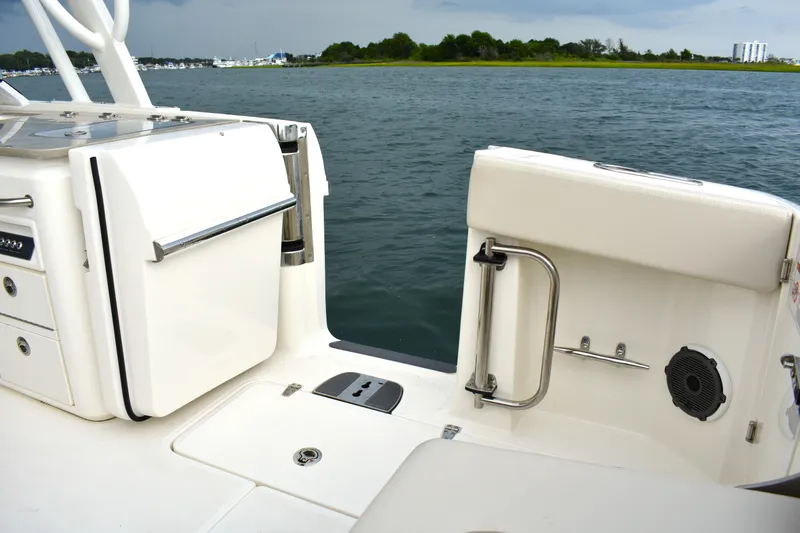  Yacht Photos Pics 2023 Boston Whaler 320 Vantage boat interior, featuring sleek white seating and stainless steel accents.