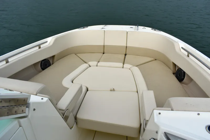  Yacht Photos Pics 2023 Boston Whaler 320 Vantage boat interior with beige seating and ocean backdrop.