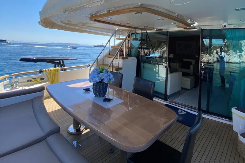  Yacht Photos Pics Luxurious 2014 Fairline Squadron 78 yacht deck with dining area and ocean view.