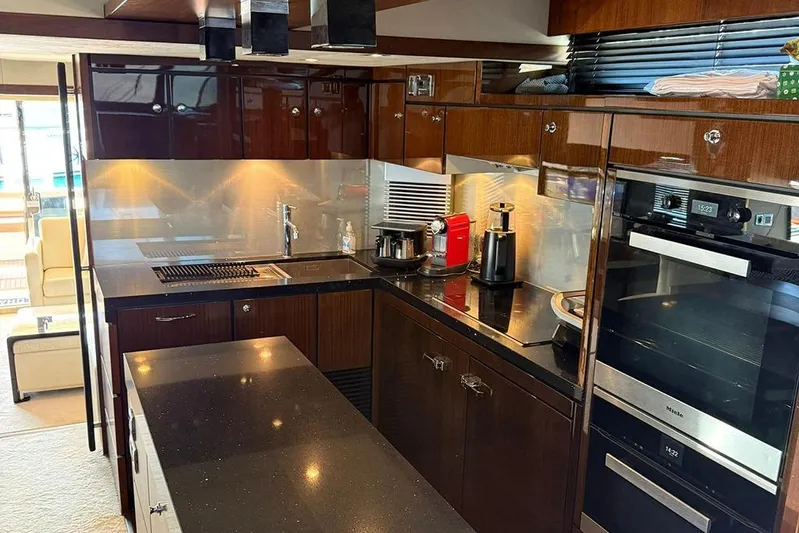  Yacht Photos Pics Luxurious kitchen interior of 2014 Fairline Squadron 78 yacht with modern appliances.