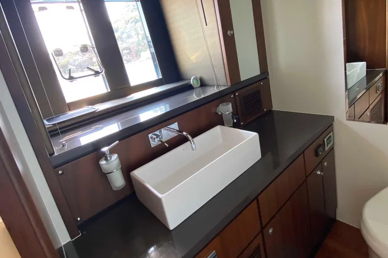  Yacht Photos Pics Luxurious bathroom interior of 2014 Fairline Squadron 78 yacht with modern sink and cabinetry.