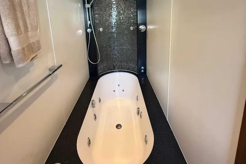  Yacht Photos Pics Luxurious bathtub in 2014 Fairline Squadron 78 yacht with modern black tile accents.