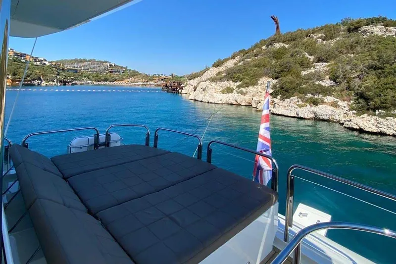  Yacht Photos Pics Luxurious 2014 Fairline Squadron 78 yacht with sunbed, scenic coastal view.