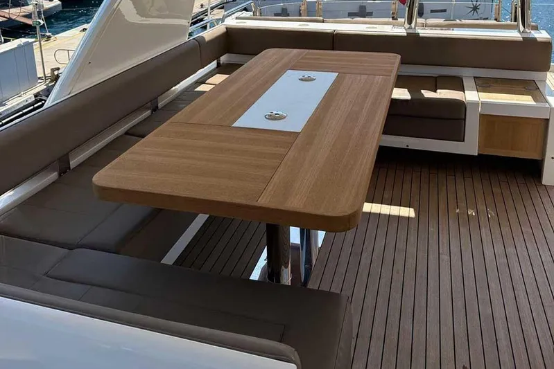  Yacht Photos Pics Luxurious 2014 Fairline Squadron 78 yacht deck with elegant wooden table and seating.