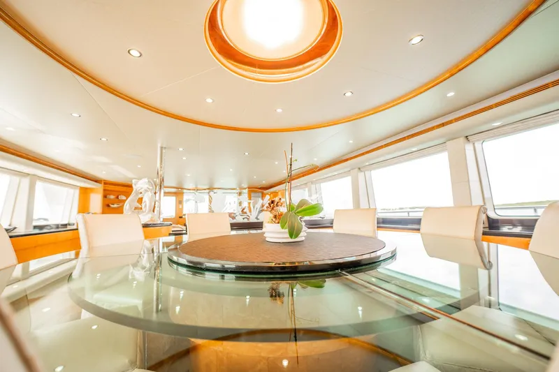 Island Heiress Yacht Photos Pics Luxurious dining area on 1996 Cheoy Lee 145 Global Series yacht, featuring elegant decor and panoramic windows.
