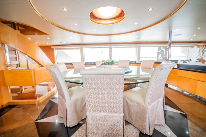 Island Heiress Yacht Photos Pics Luxurious dining area on 1996 Cheoy Lee 145 Global Series yacht, featuring elegant decor and panoramic windows.