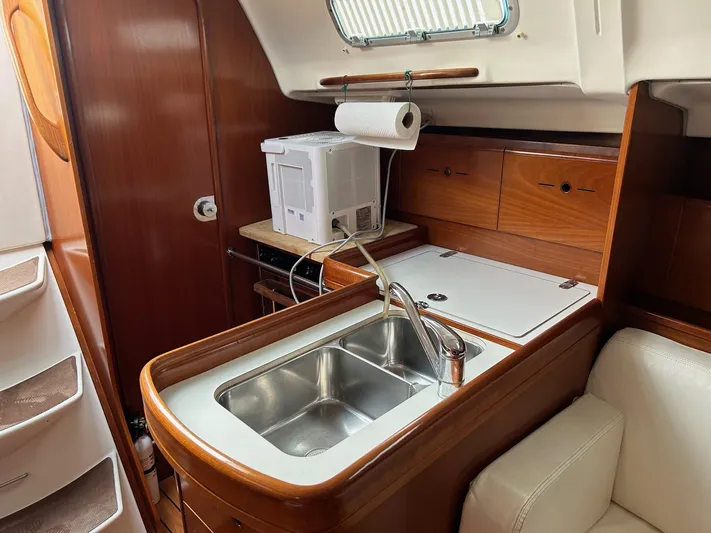 Flaneuse Yacht Photos Pics Beneteau 36.7 2003 yacht interior kitchen with sink and microwave.