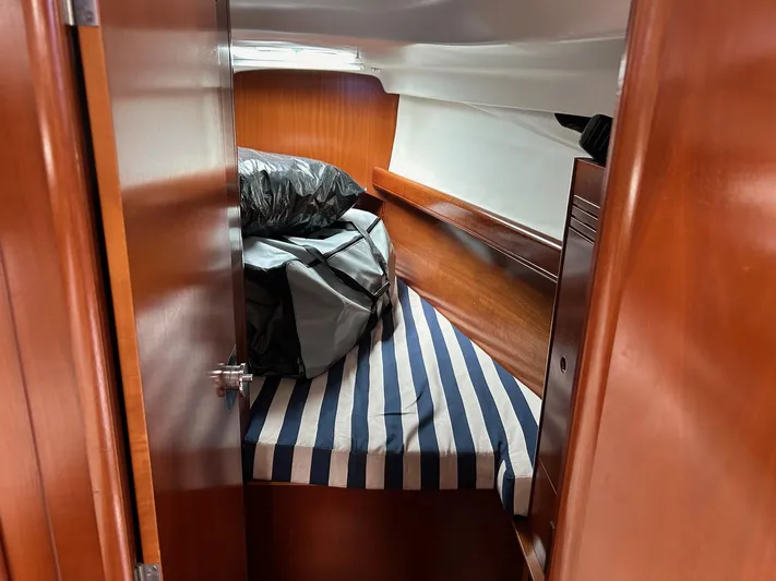 Flaneuse Yacht Photos Pics Cozy cabin interior of 2003 Beneteau 36.7 sailboat with striped bedding.