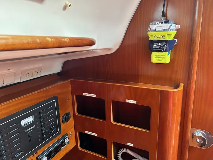 Flaneuse Yacht Photos Pics Interior of 2003 Beneteau 36.7 yacht with navigation equipment and storage compartments.