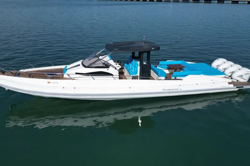 Inflation Yacht Photos Pics 2021 Capelli Tempest 50 boat with sleek design and blue seating on calm water.