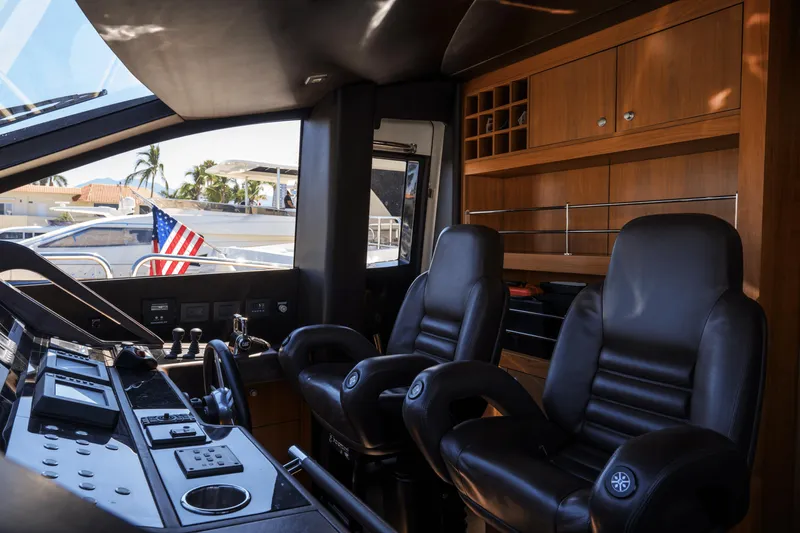 Kastelan Yacht Photos Pics Interior of 2015 Sunseeker 28 Metre Yacht with leather seats and control panel.