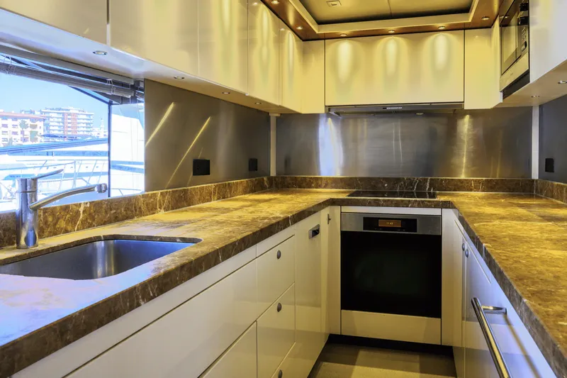 Kastelan Yacht Photos Pics Luxurious kitchen interior of 2015 Sunseeker 28 Metre Yacht with modern appliances.