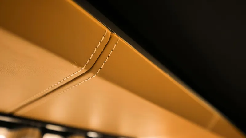 Elisa II Yacht Photos Pics Close-up of tan leather stitching detail on 2018 Azimut 77 S yacht interior.