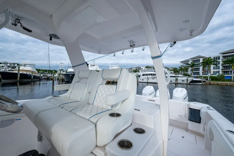 Mrs Diagnosis Yacht Photos Pics Luxury seating on a 2020 Intrepid 407 Panacea boat docked at a marina.