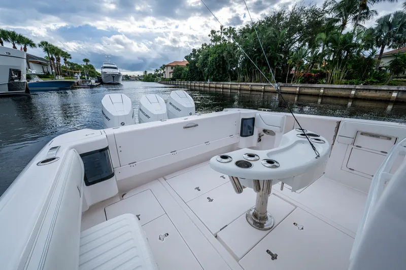 Mrs Diagnosis Yacht Photos Pics Intrepid 407 Panacea 2020 boat with fishing setup, docked in a scenic canal.