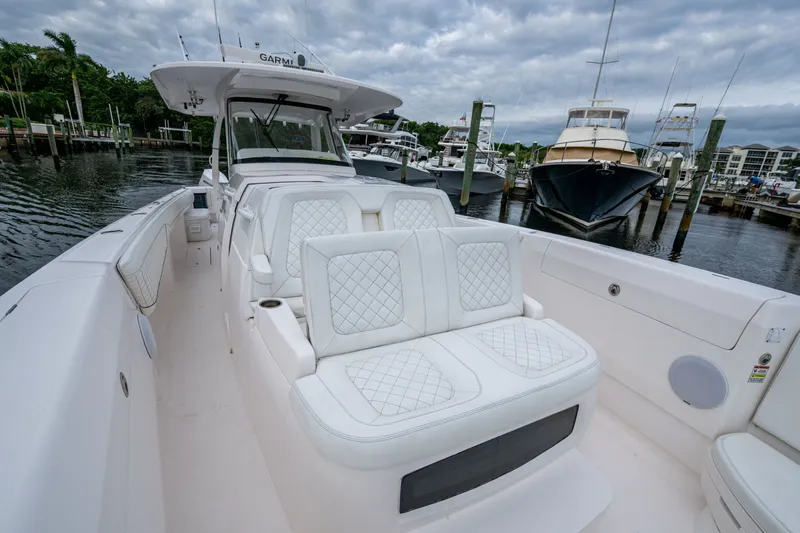 Mrs Diagnosis Yacht Photos Pics 2020 Intrepid 407 Panacea boat with luxurious white seating at a marina.