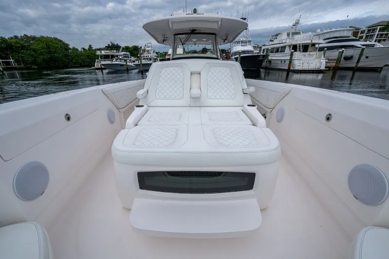 Mrs Diagnosis Yacht Photos Pics 2020 Intrepid 407 Panacea boat with luxurious white seating in a marina setting.