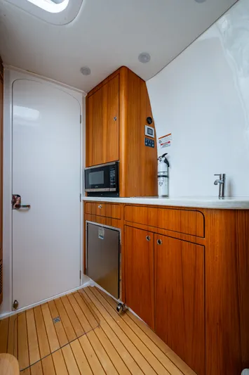 Mrs Diagnosis Yacht Photos Pics Interior of 2020 Intrepid 407 Panacea boat with wooden cabinetry and modern amenities.