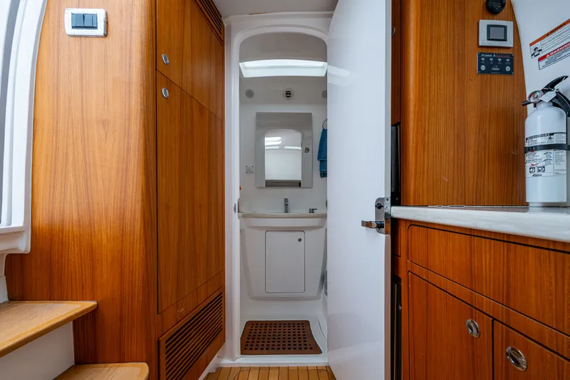 Mrs Diagnosis Yacht Photos Pics Interior of 2020 Intrepid 407 Panacea boat, featuring wooden cabinetry and compact bathroom.