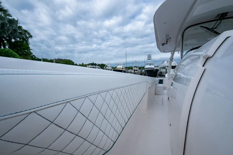 Mrs Diagnosis Yacht Photos Pics 2020 Intrepid 407 Panacea boat with sleek design, docked under cloudy skies.