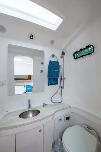 Mrs Diagnosis Yacht Photos Pics Bathroom interior of 2020 Intrepid 407 Panacea boat, featuring sink, mirror, and shower.