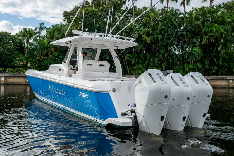 Mrs Diagnosis Yacht Photos Pics 2020 Intrepid 407 Panacea boat with triple outboard engines on a calm waterway.