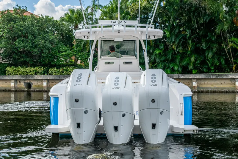 Mrs Diagnosis Yacht Photos Pics 2020 Intrepid 407 Panacea boat with triple 400 horsepower engines on a calm waterway.