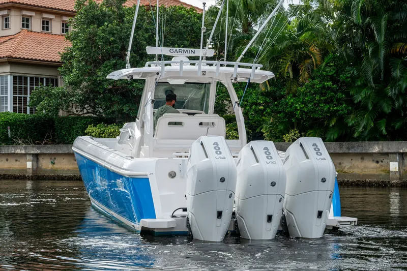 Mrs Diagnosis Yacht Photos Pics 2020 Intrepid 407 Panacea boat with triple 400 horsepower engines on a calm waterway.