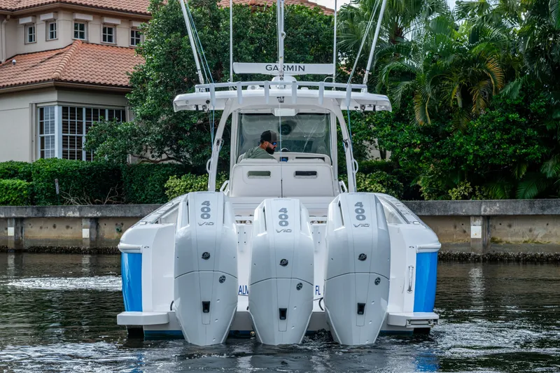 Mrs Diagnosis Yacht Photos Pics 2020 Intrepid 407 Panacea boat with triple 400 V10 engines on a calm waterway.