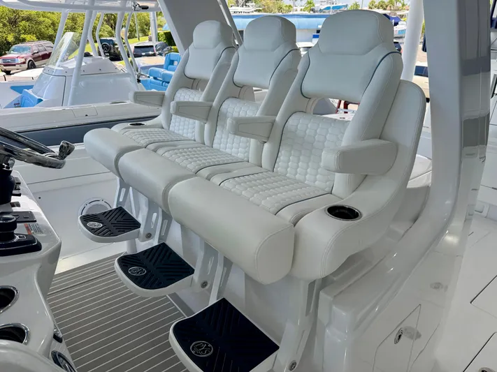  Yacht Photos Pics Luxury seating on 2025 Intrepid 41 Panacea boat, featuring white cushioned seats and armrests.