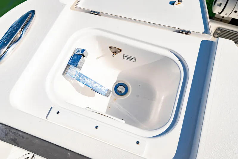  Yacht Photos Pics Livewell compartment on 2022 Crevalle 33 CSF boat, featuring non-potable water label.