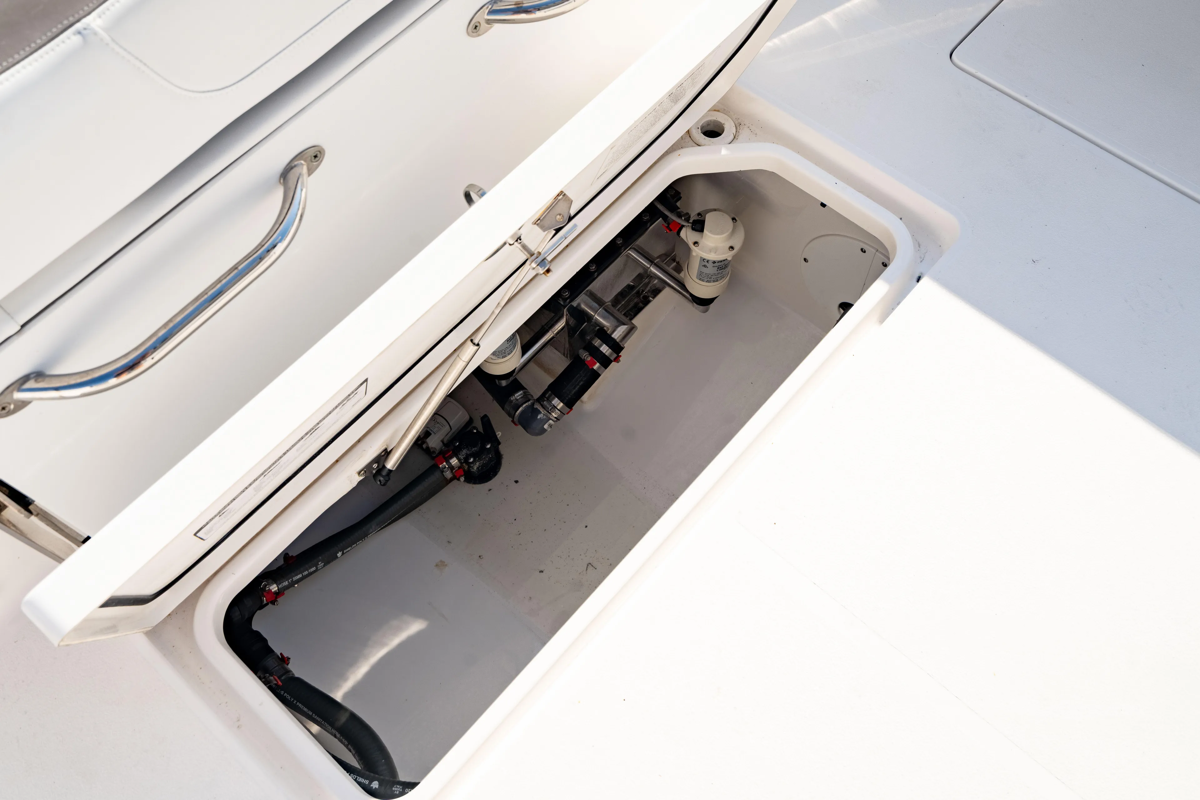  Yacht Photos Pics Open storage compartment on 2022 Crevalle 33 CSF boat, showing internal components and fittings.